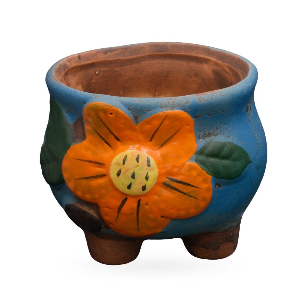 Blue painted terracotta footed pot with a raised orange flower and green leaves