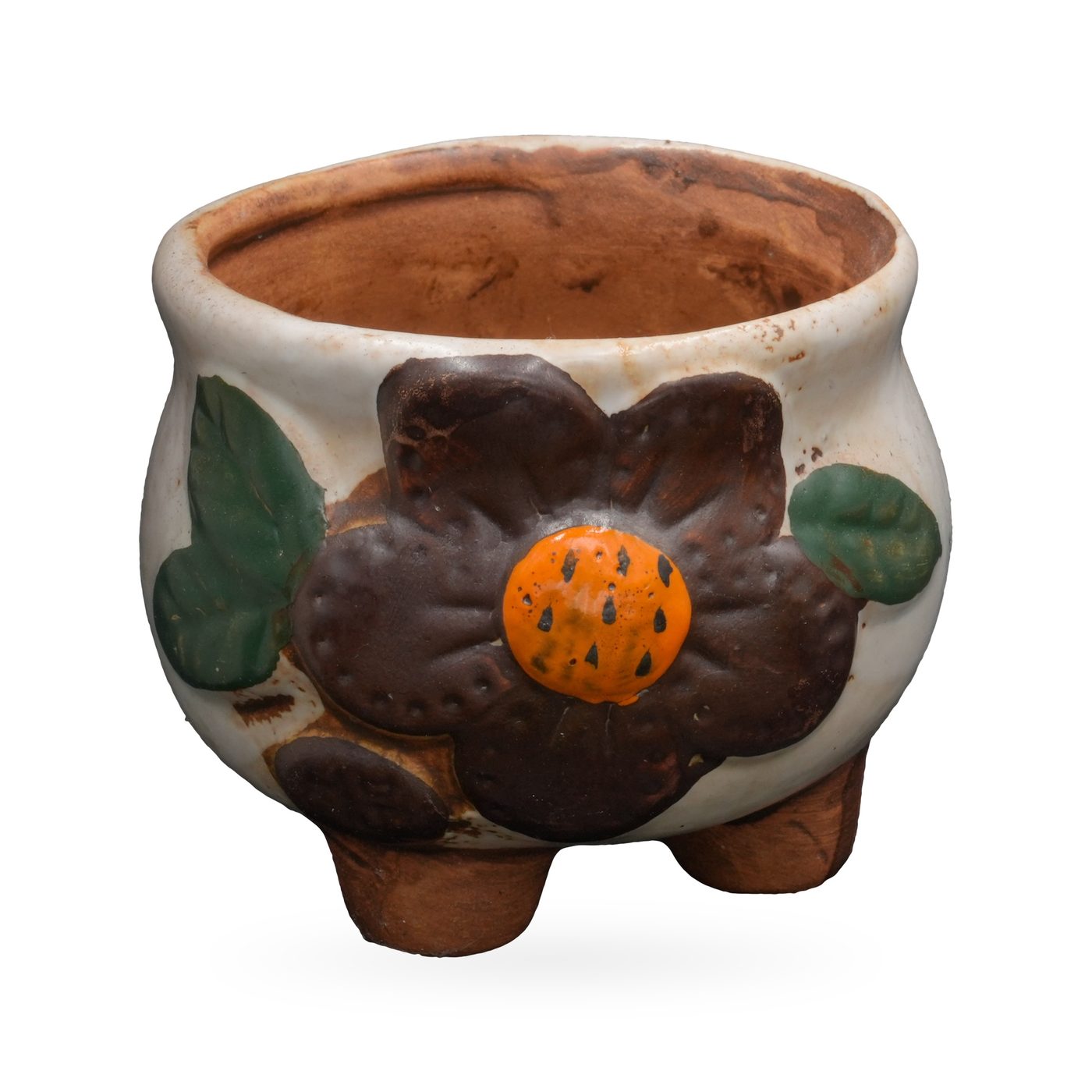 Cream painted terracotta footed pot with a raised brown flower, orange centre and green leaves
