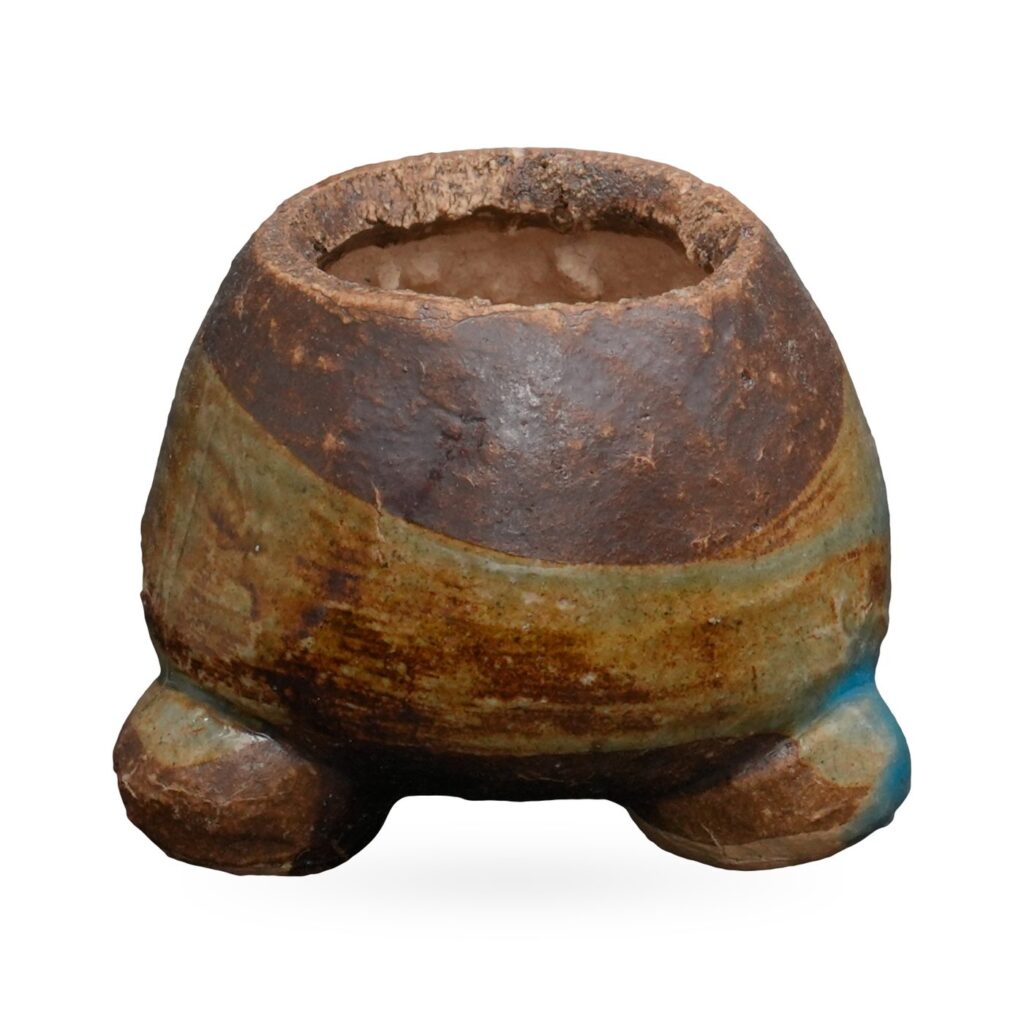 Mini brown coarse-clay pot with sage-green and turquoise glaze band on small rounded feet