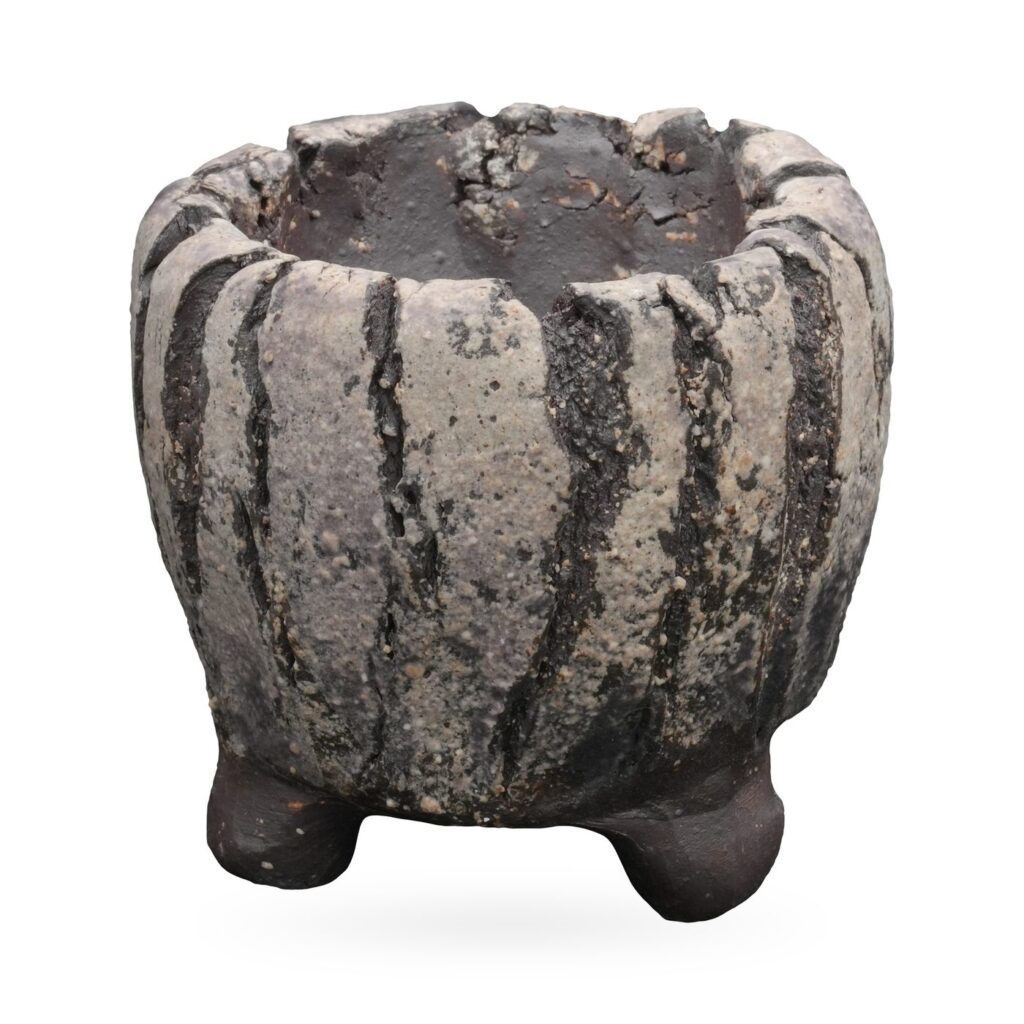 Round stone-grey and charcoal striped textured pot with craggy rim and small dark clay feet