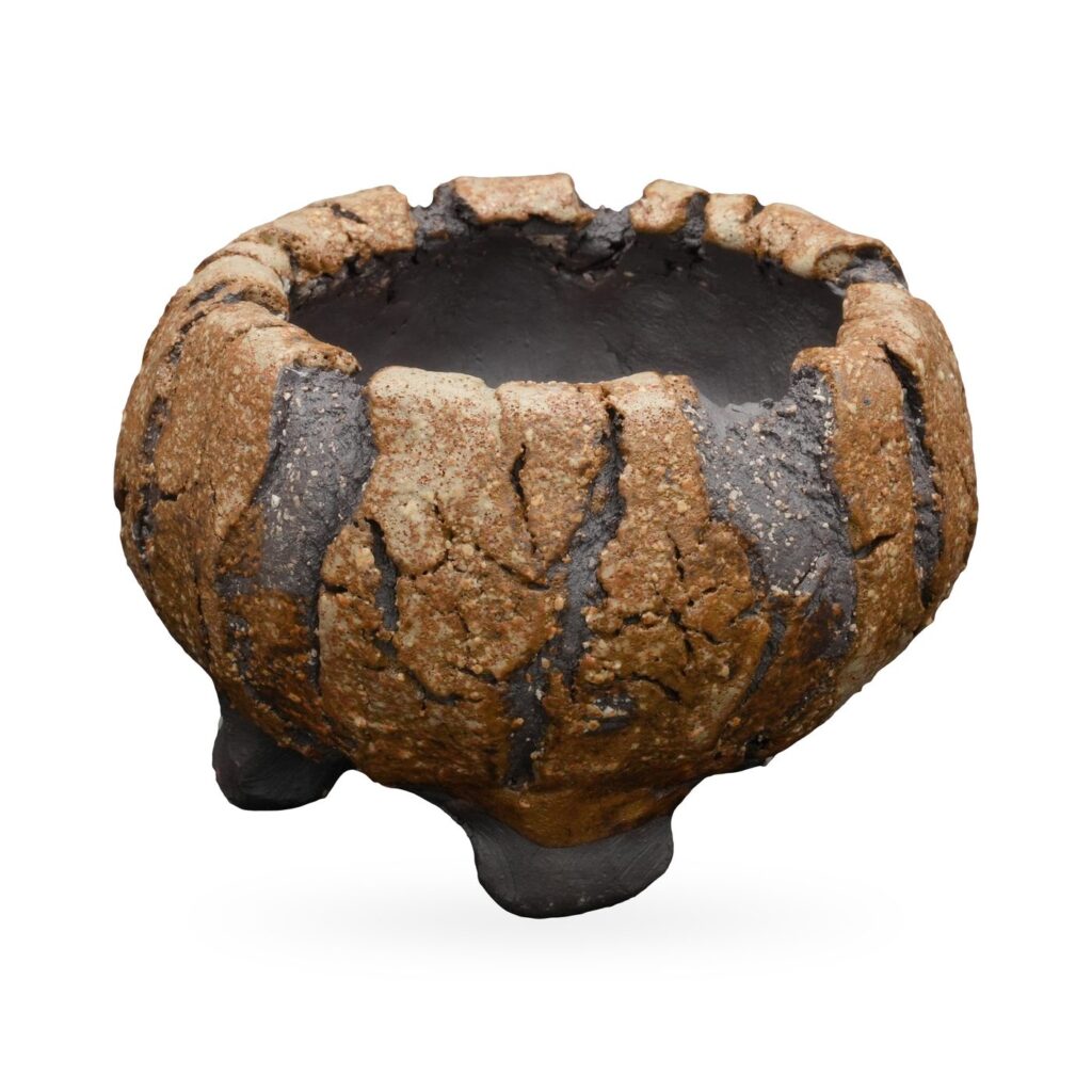 Wide ochre-tan and charcoal striped textured pot with chunky scalloped rim and small dark feet
