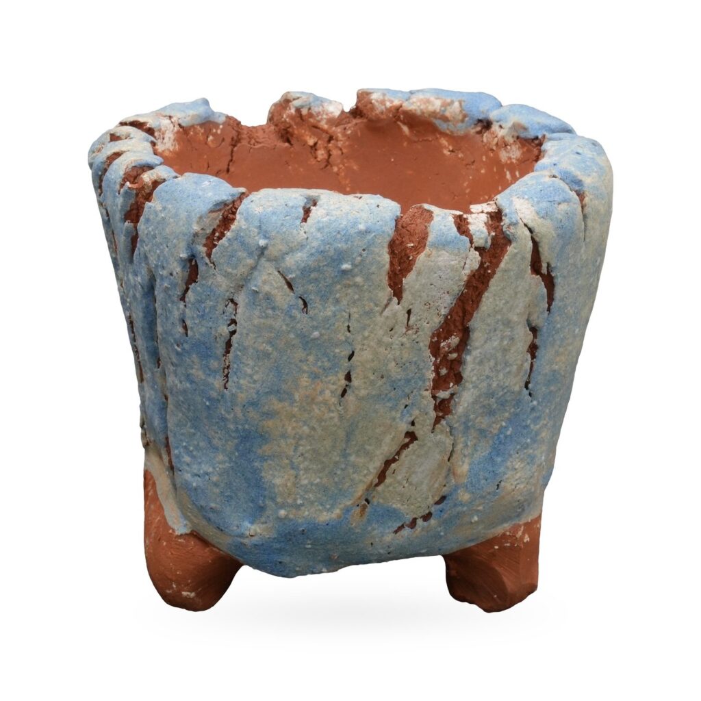 Footed terracotta pot with a crackled pale blue and white coating showing red clay through the cracks