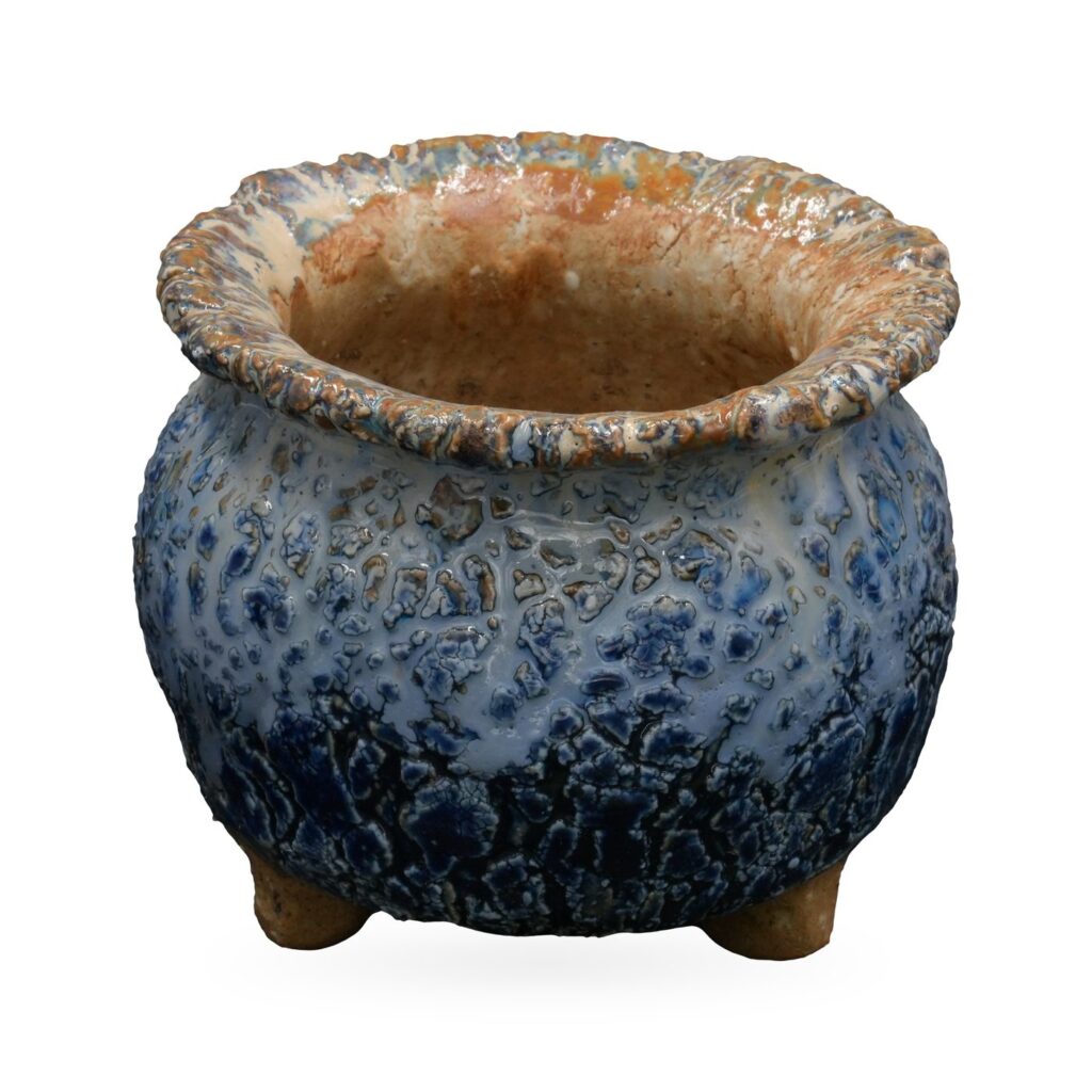 Round footed pot in mottled cobalt and pale blue crackle glaze with a textured tan rolled rim