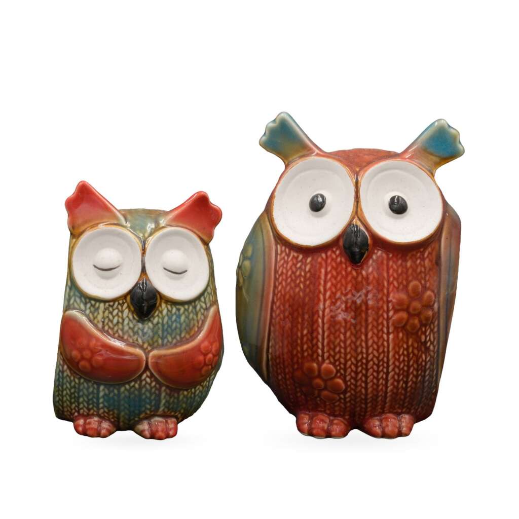 Two glossy ceramic knit-texture owl ornaments side by side: a small sleeping teal and coral owl and a larger wide-eyed brick red owl