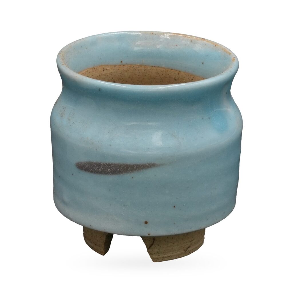 Pale sky-blue glazed footed pot with a charcoal brushstroke accent and rough-cut clay feet