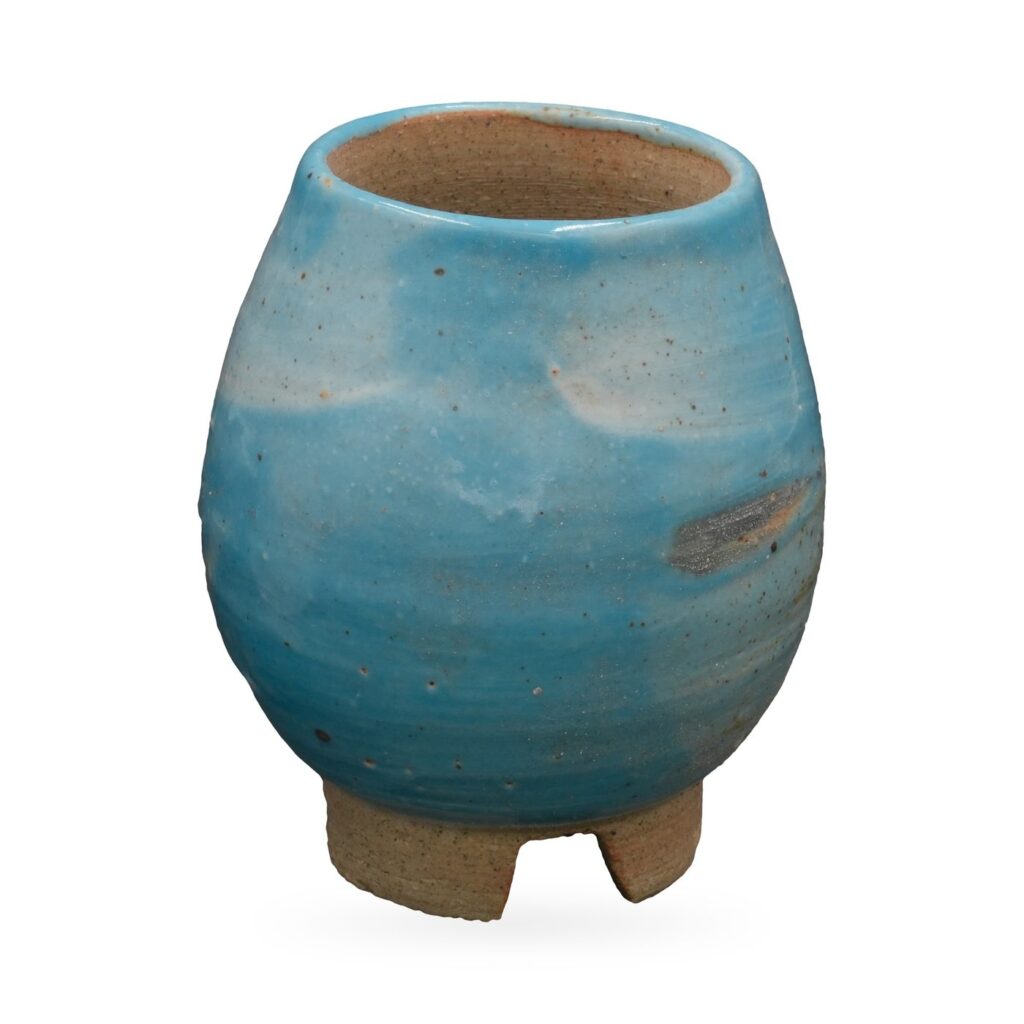 Tall egg-shaped pot in glossy sky-blue glaze with white patches on small unglazed clay feet