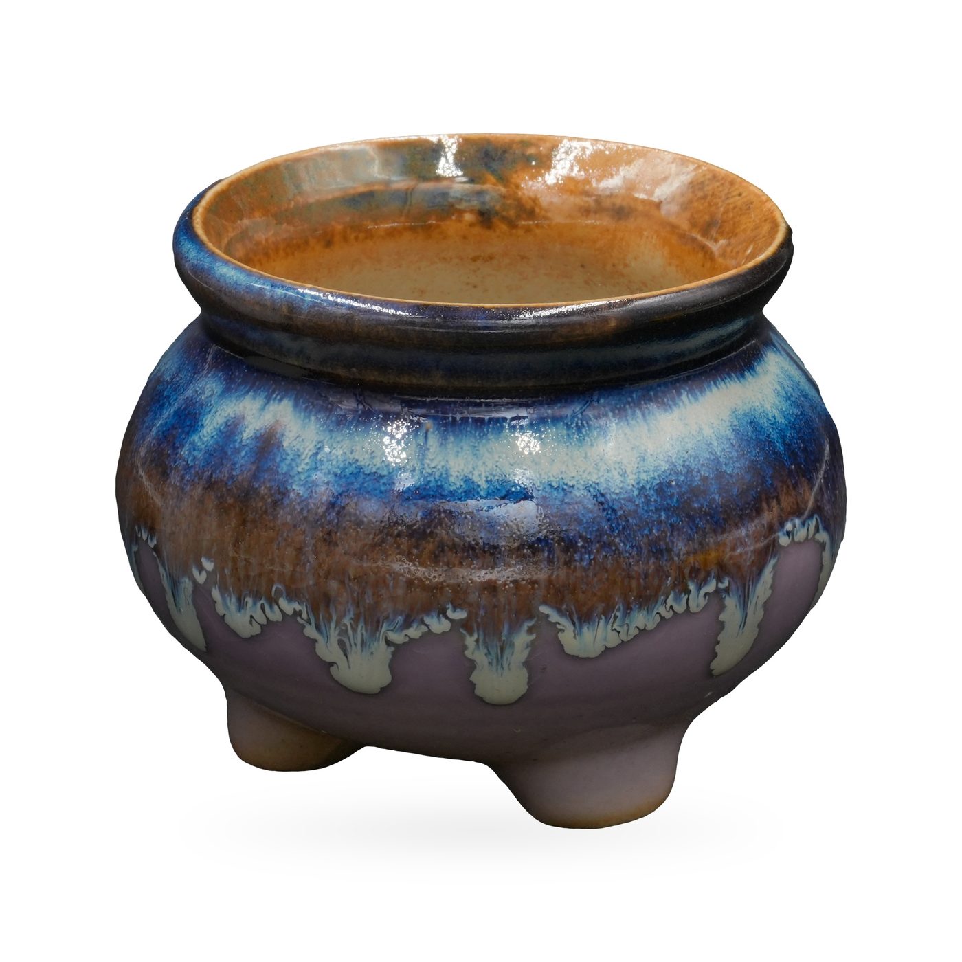 Footed round pot with glossy cobalt-blue glaze dripping over lavender and a rust-amber rim