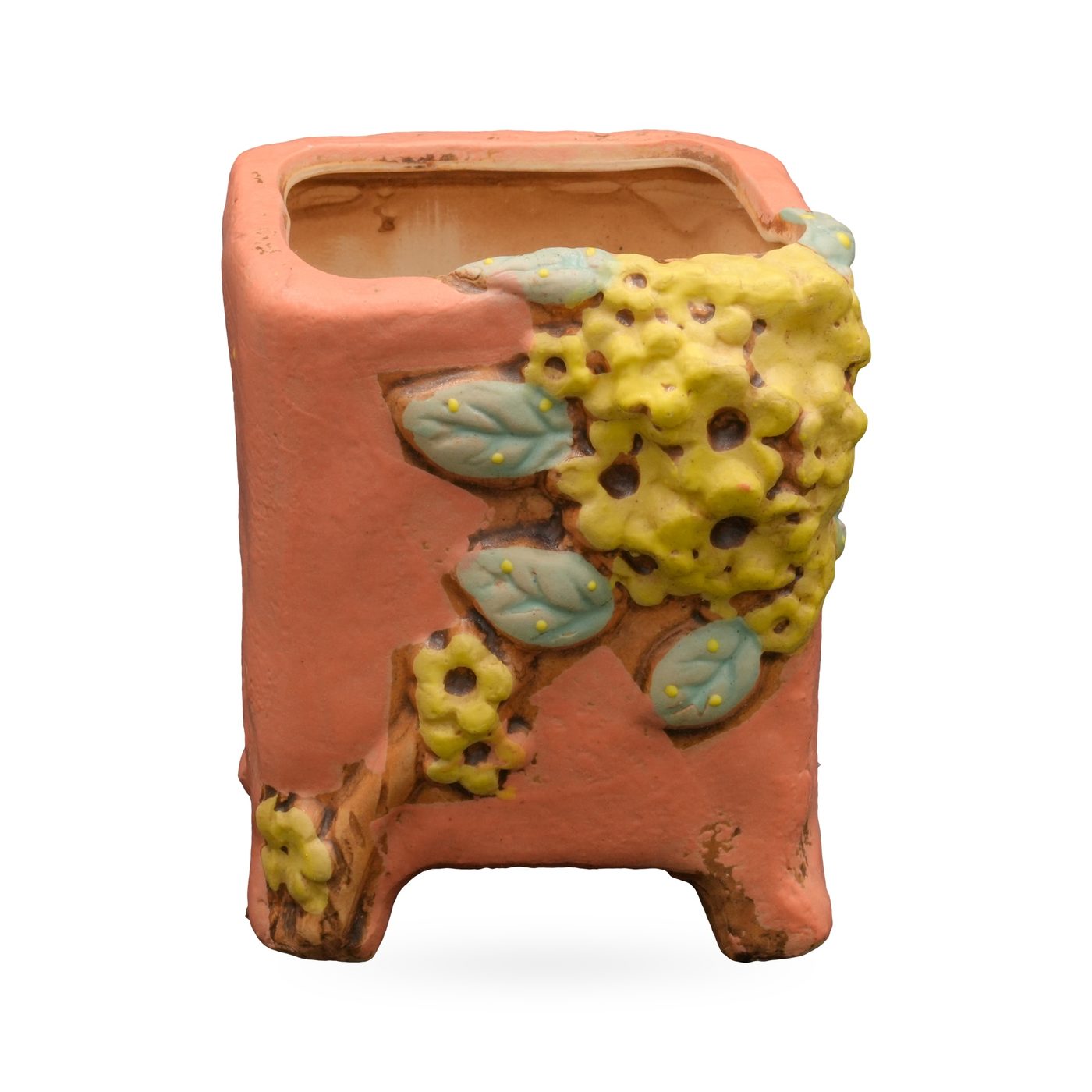Coral-orange square footed pot with raised yellow flower and blue-green leaf relief on one corner – view 2