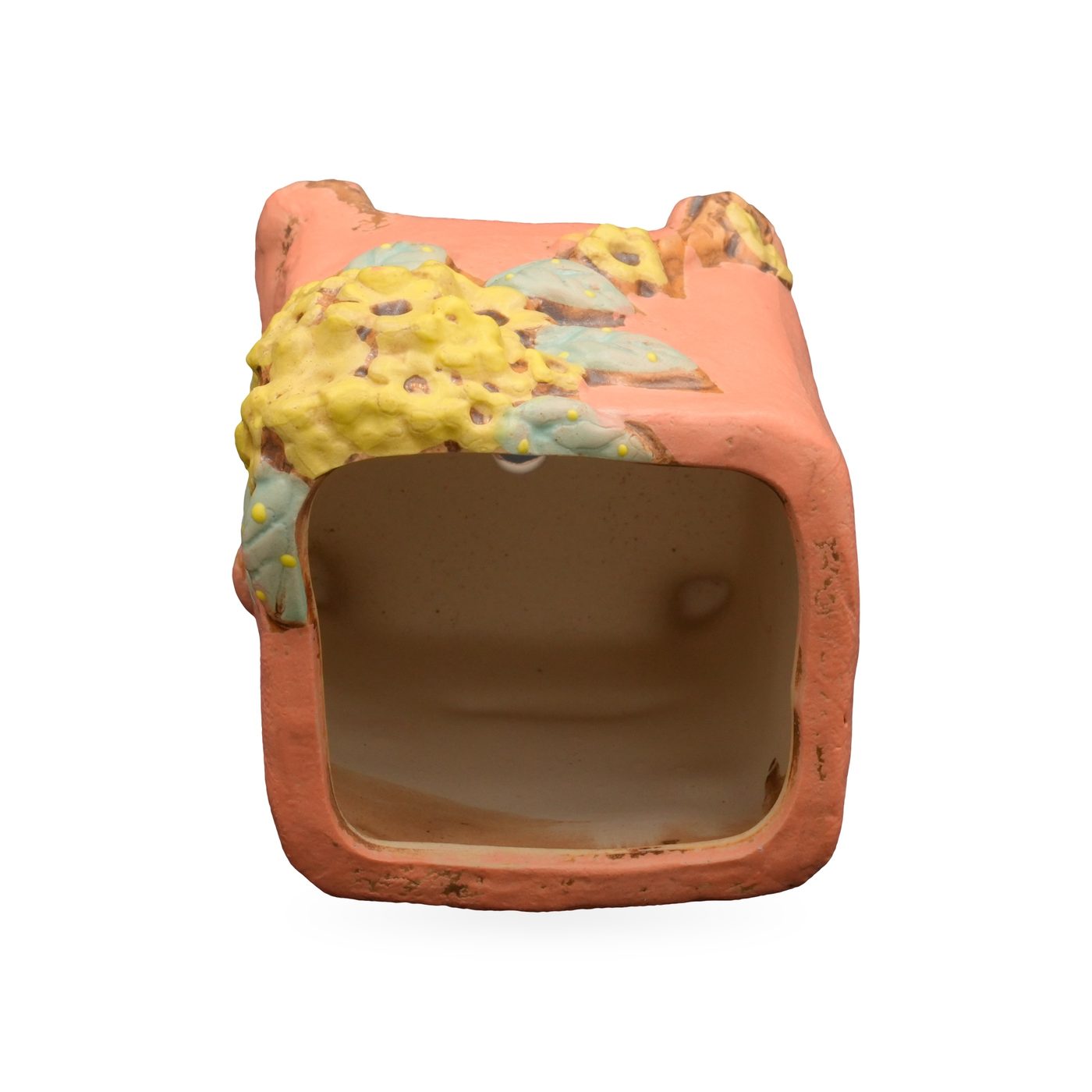 Coral-orange square footed pot with raised yellow flower and blue-green leaf relief on one corner – view 3