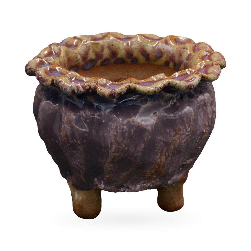 Plum-purple glazed round pot with amber scalloped rim and small clay feet