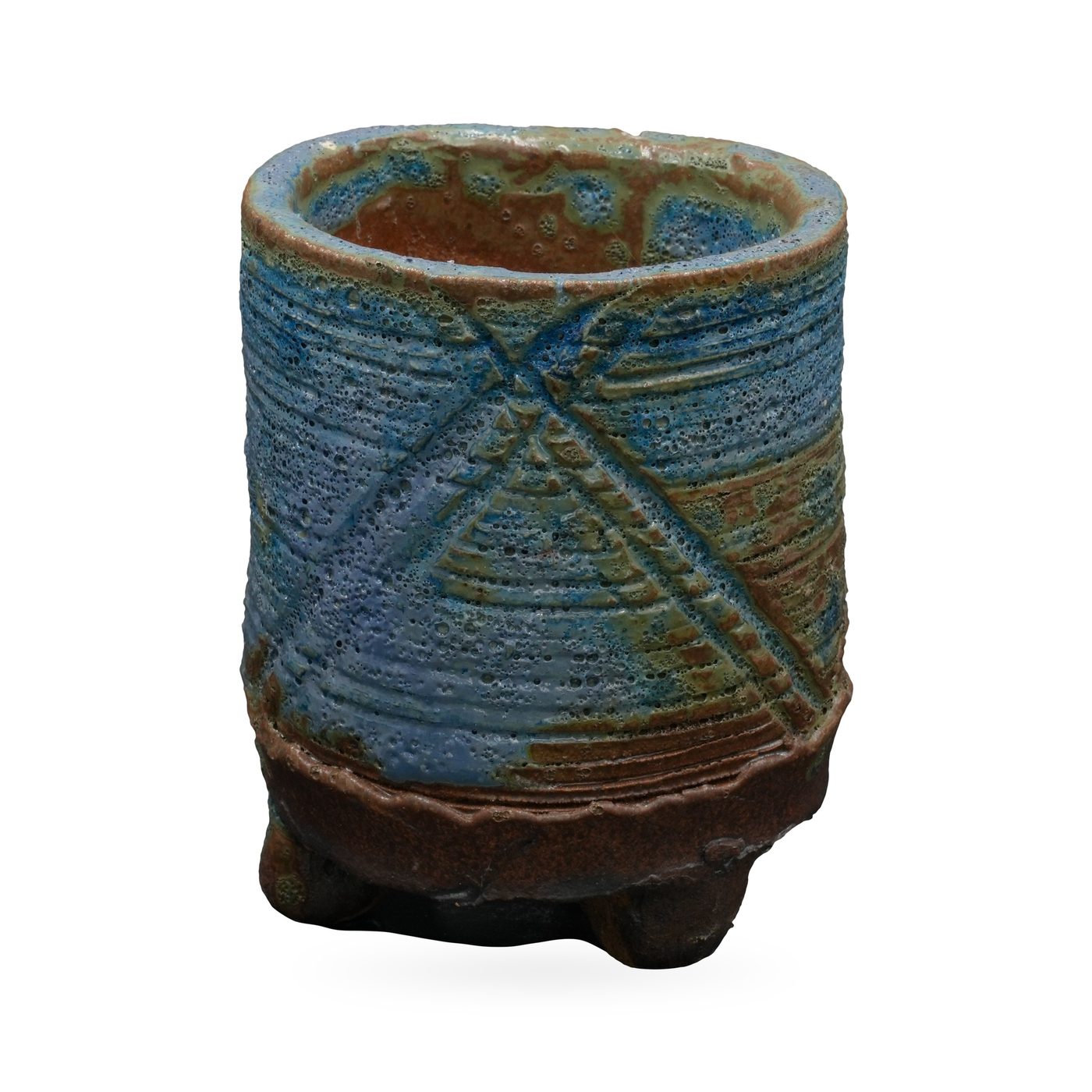 Tall blue-green cylinder pot with pitted lava-style glaze, raised X pattern and dark brown footed base