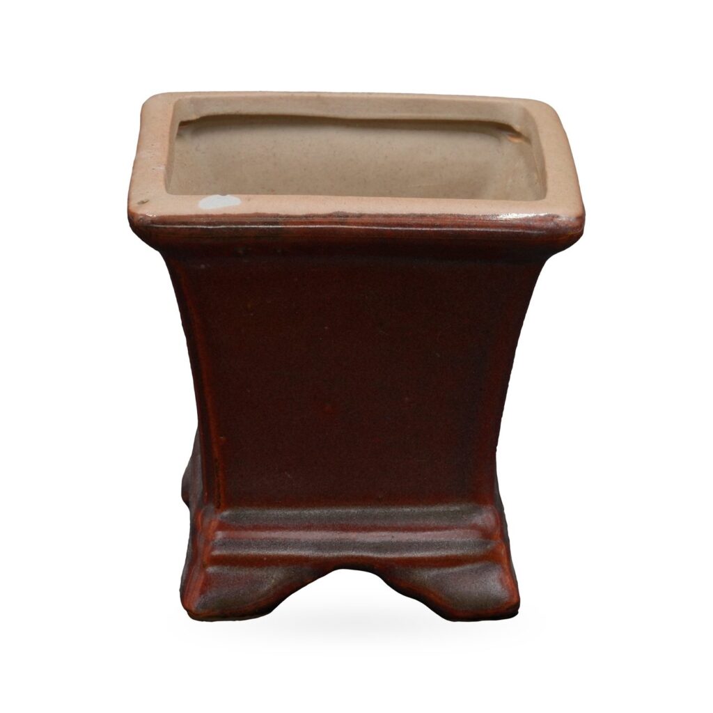 Flared square pot in glossy maroon with buff clay rim, banded base and small shaped feet