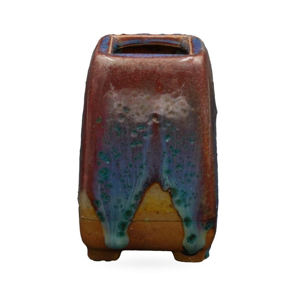 Tall square succulent pot in glossy oxblood-red glaze with blue and turquoise drips, on small feet