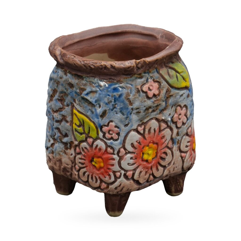 Blue textured footed succulent pot with raised coral, pink and white flowers and green leaves – view 2