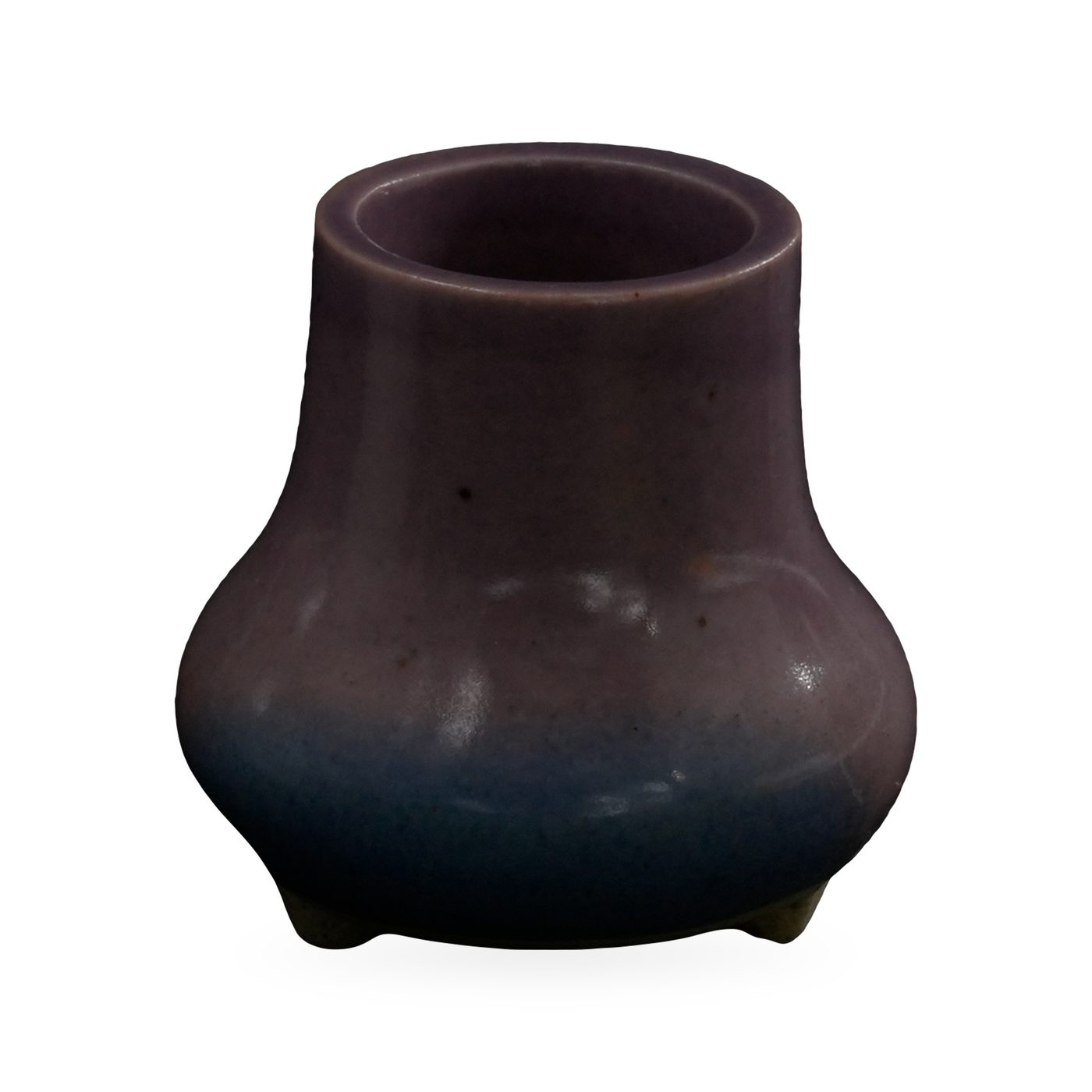 Tiny purple vase-shaped succulent pot fading to blue at the base, on small cream feet