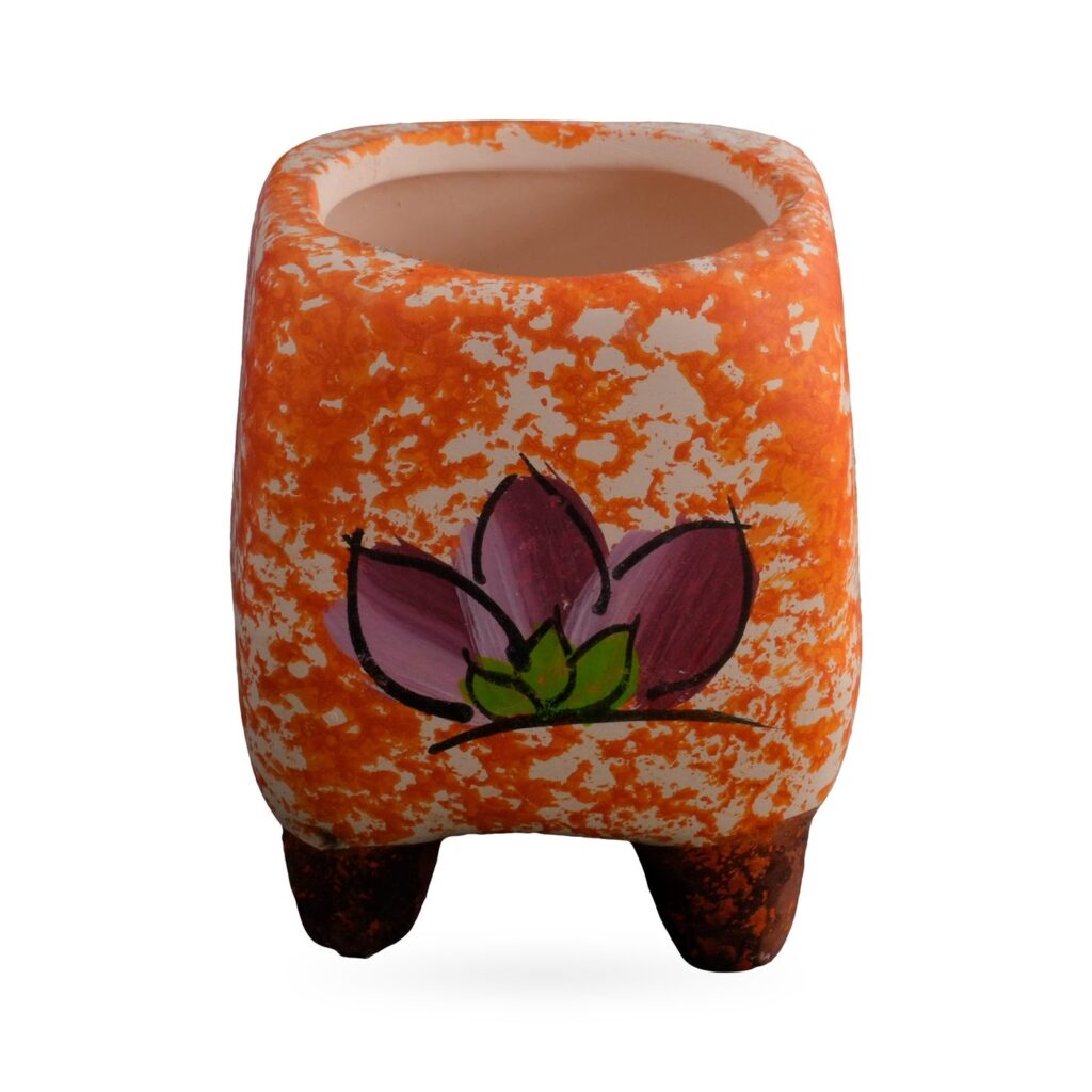 Small square orange speckled pot with a pink-purple flower design on dark-brown feet