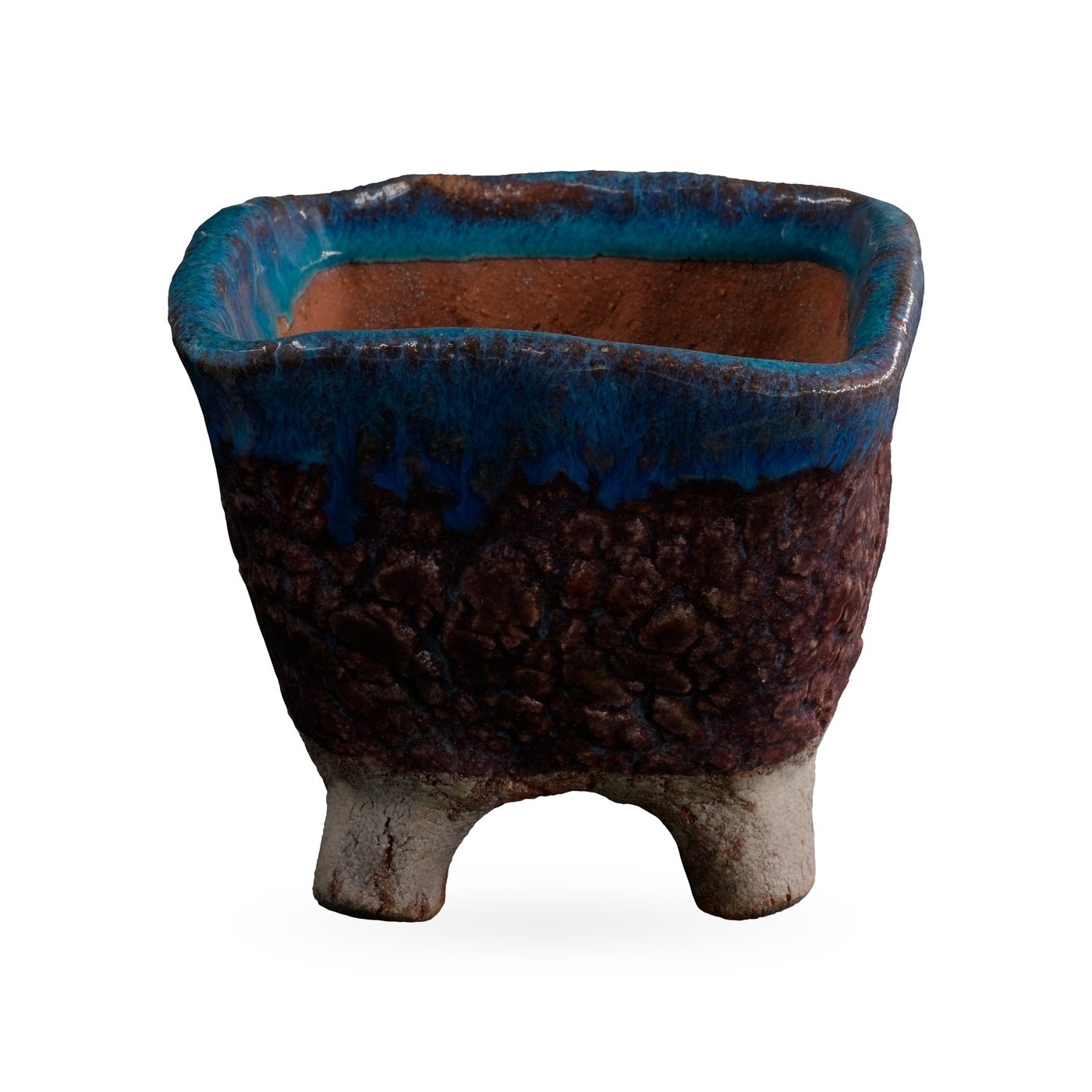 Square footed pot with a glossy teal-blue drip rim, textured plum-brown body and pale feet, 10.5×8.5cm