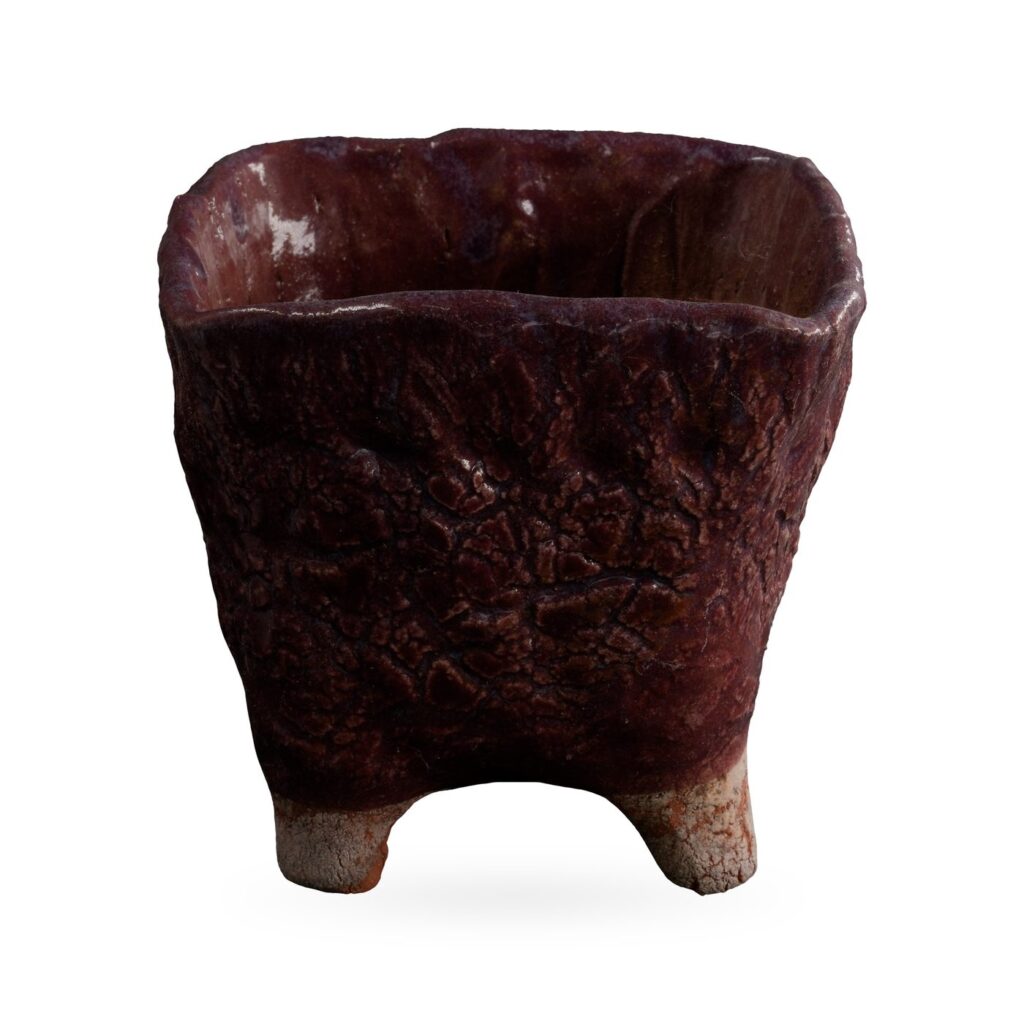 Square maroon textured-glaze pot on pale unglazed feet, 11×10cm