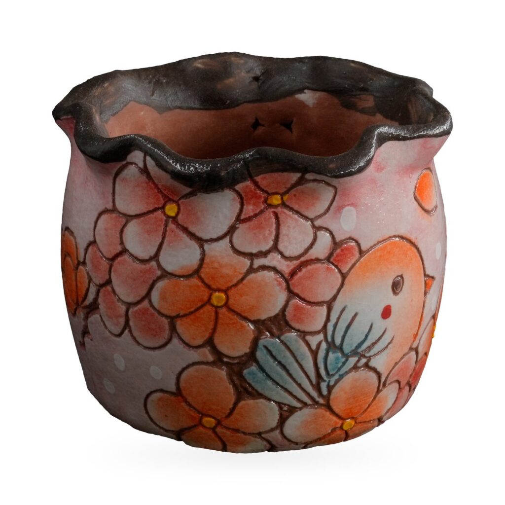 Pink painted succulent pot with orange blossoms, a small bird and a wavy dark rim