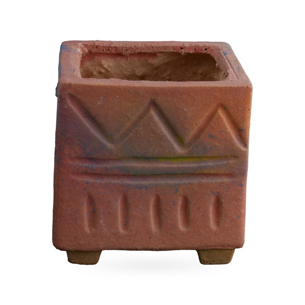 Matte dusty pink square pot with raised zigzag and dash pattern, on small feet