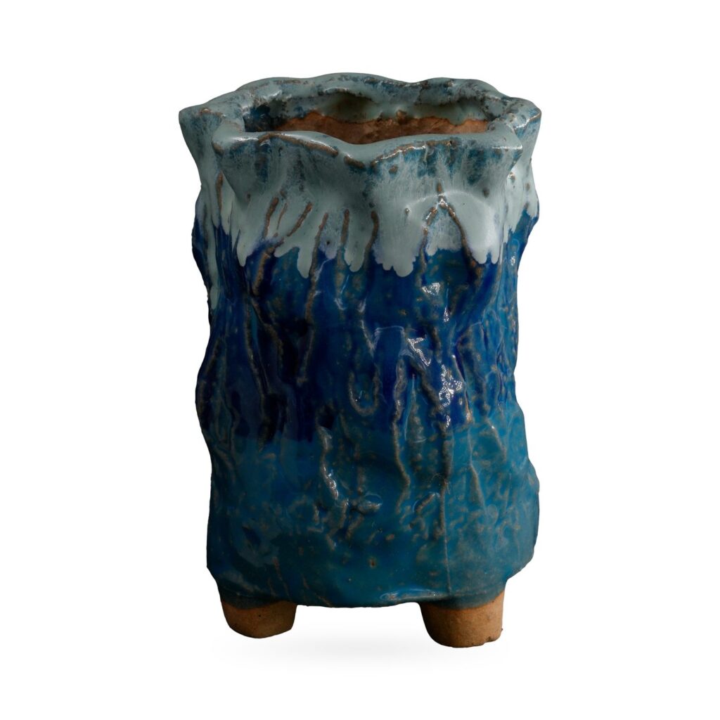 Tall cobalt and teal bark-textured footed pot with pale blue-white glaze dripping from a wavy rim