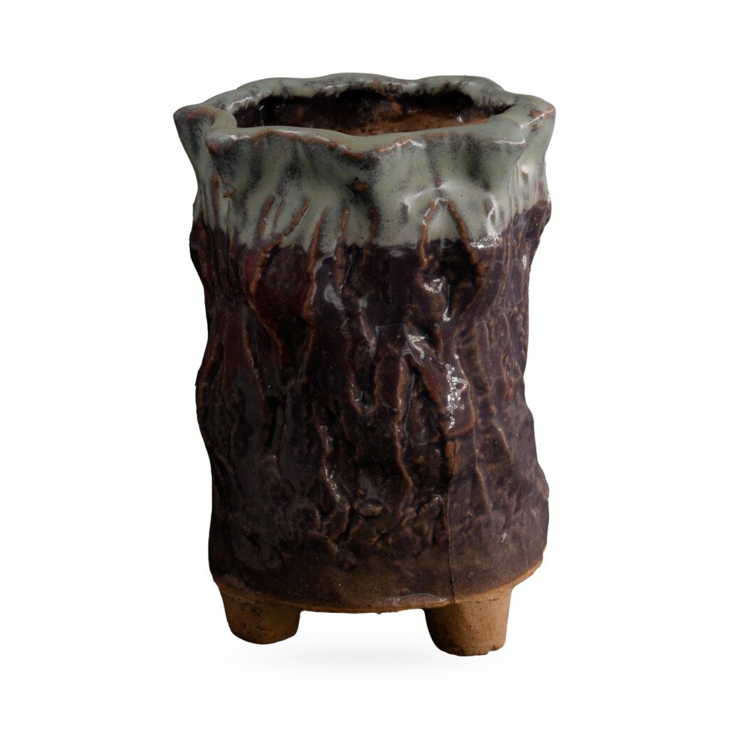 Tall plum-brown bark-textured footed pot with sage green glaze dripping from a wavy rim