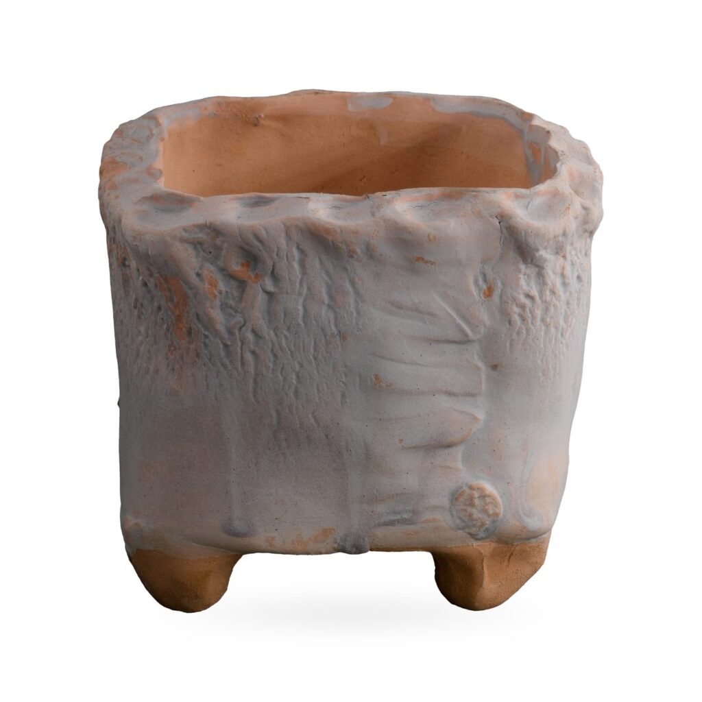 Pale white-blue square footed pot with feather-like ridge, round stamped motif and scalloped rim