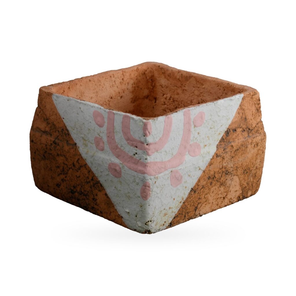 Low orange square pot with dark mottling and a white triangular corner panel with pink arc-and-dot motif