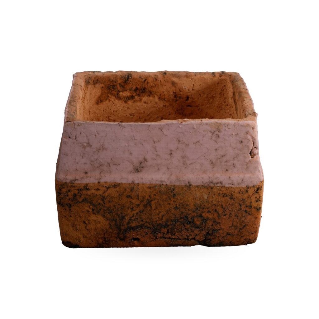 Low orange square pot with dark mottling and a wide soft pink band around the upper sides