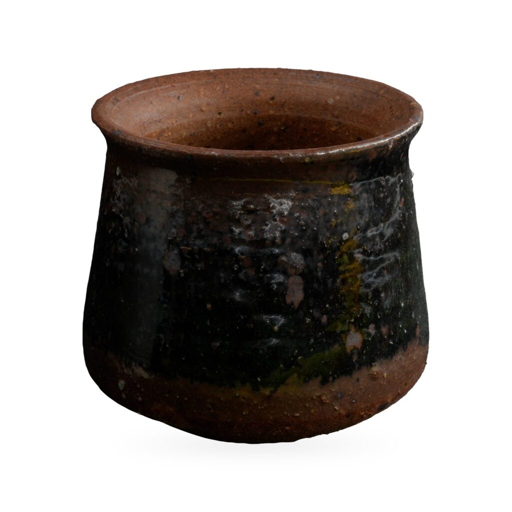 Round pot with flared rim in glossy black glaze with olive streaks over speckled reddish-brown clay