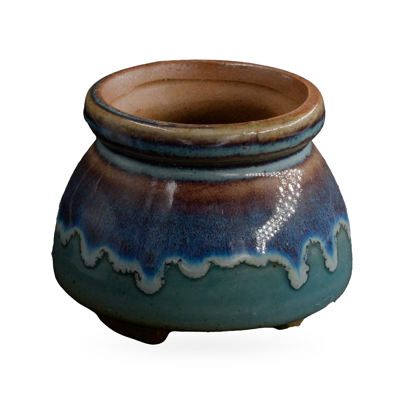 Squat round footed pot with glossy teal base, blue-purple drip band and speckled brown rolled rim