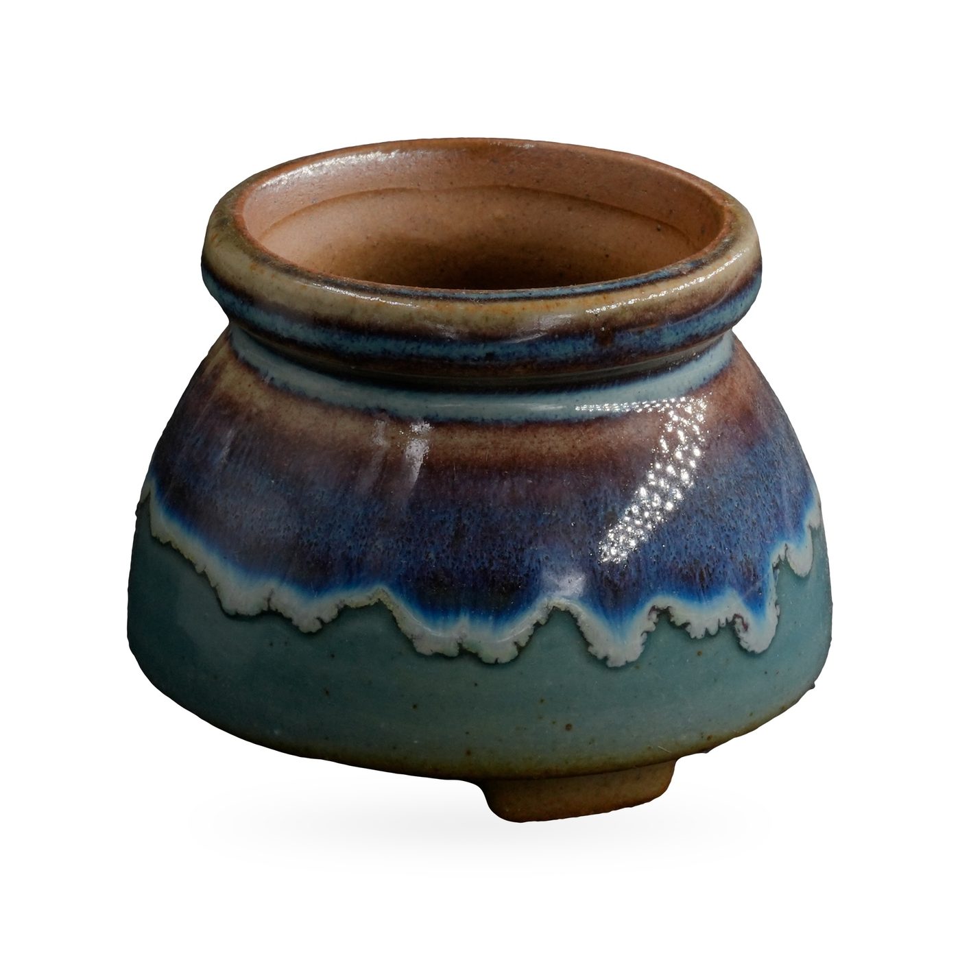 Squat round footed pot with glossy teal base, blue-purple drip band and speckled brown rolled rim – view 2