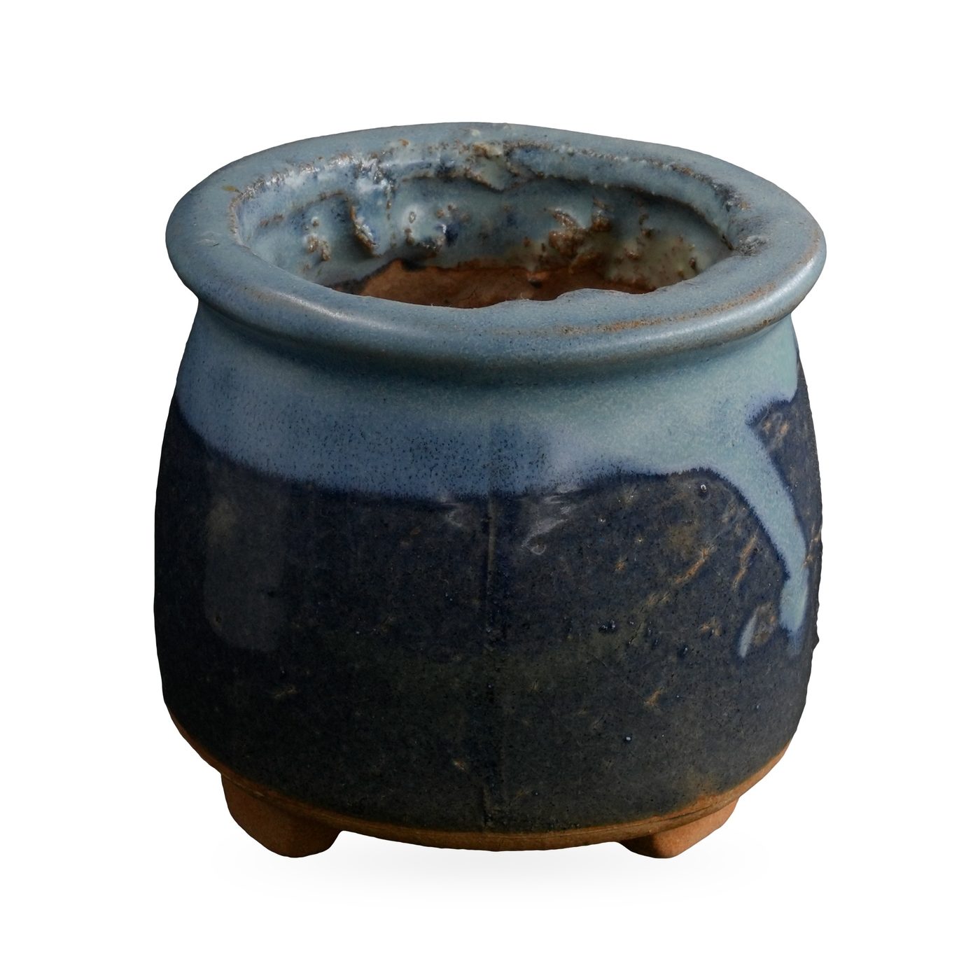 Navy blue footed succulent pot with glossy pale sky-blue glaze dripping down from the rim