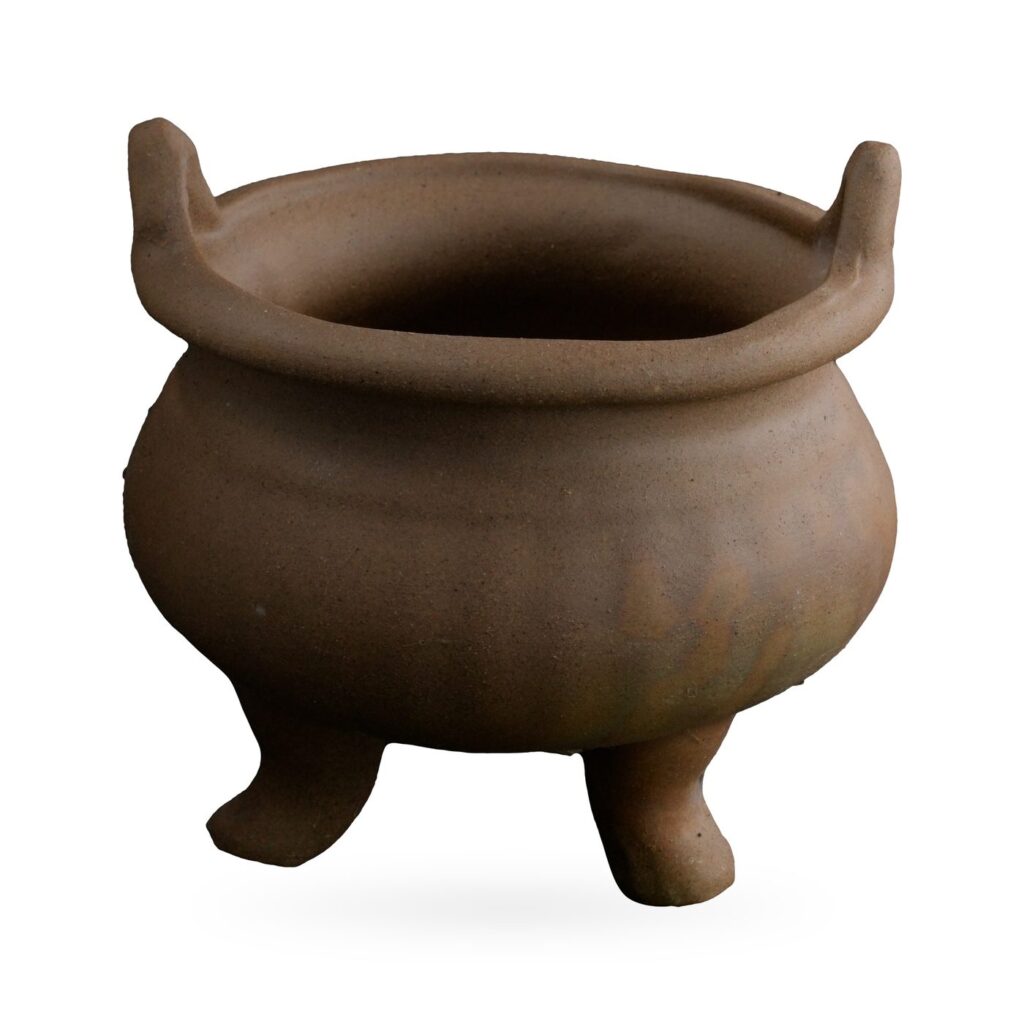 Brown clay cauldron-style succulent pot with a rounded belly, two upright ear handles and short legs