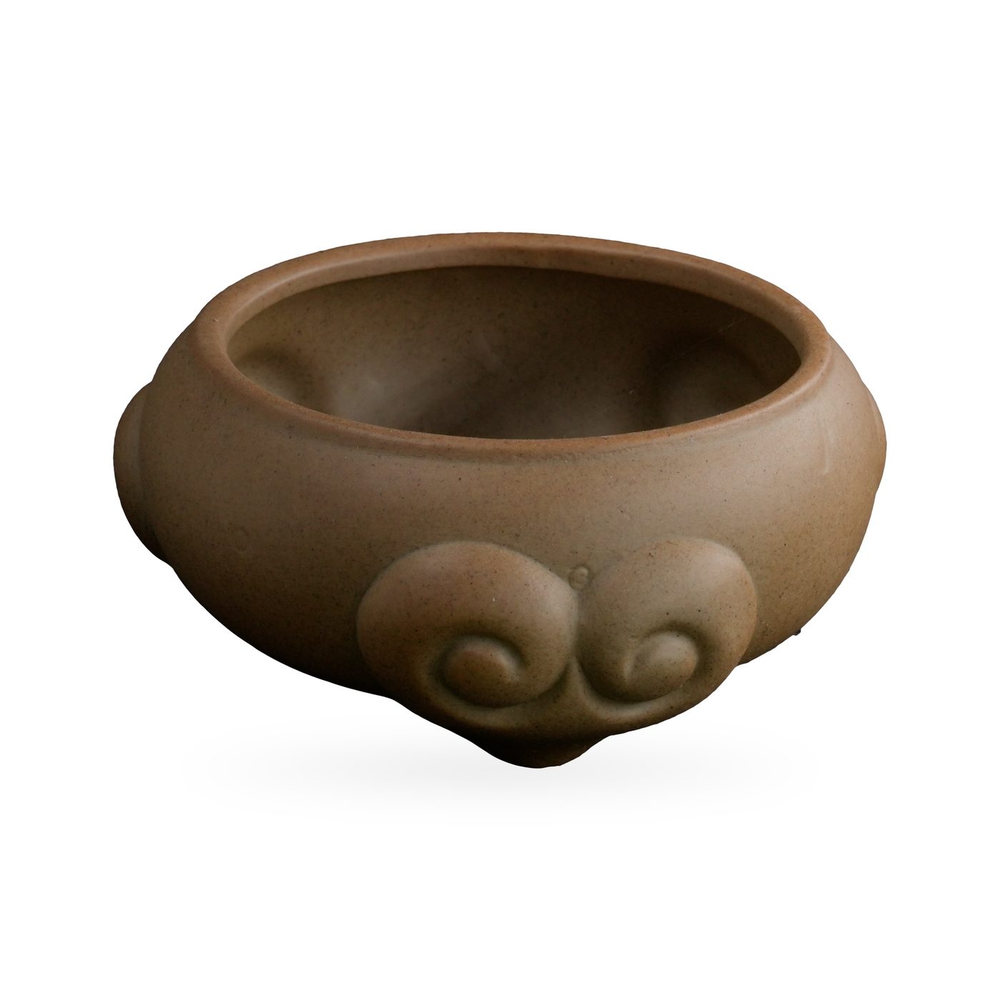Low khaki tan succulent bowl with raised scroll-like swirl motifs that form its small feet