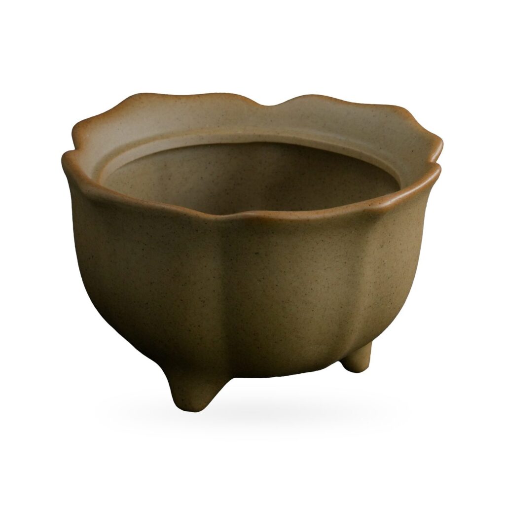 Khaki tan footed succulent pot with a scalloped petal-like rim and softly panelled sides
