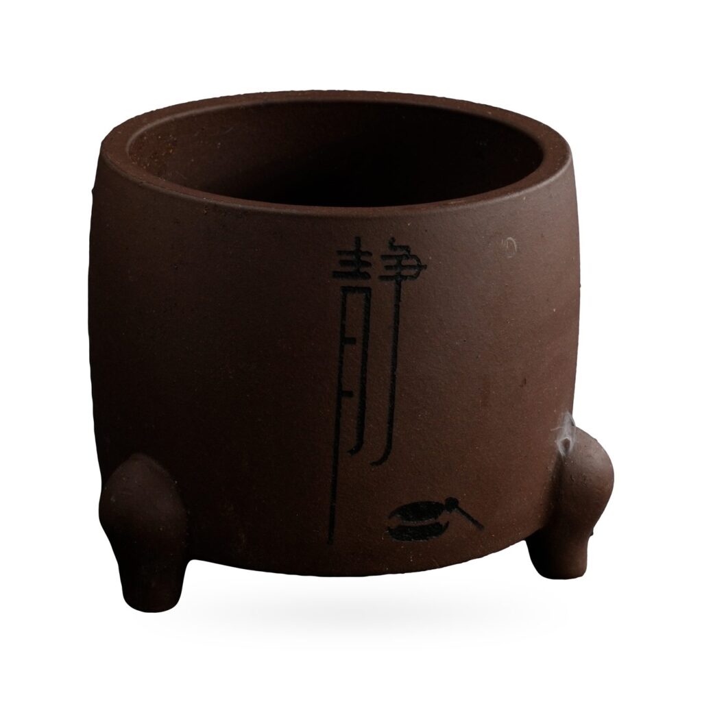 Drum-shaped matte purple-brown footed pot with a tall black calligraphy character