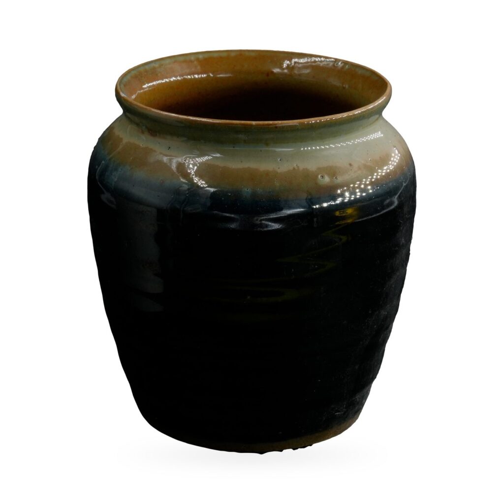 Rounded black glazed jar pot with a pale sage and blue-grey shoulder band and a brown rim