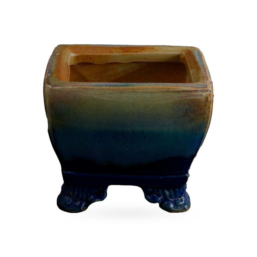 Square pot in glossy glaze fading from amber and sage at the rim to cobalt blue at the base and feet