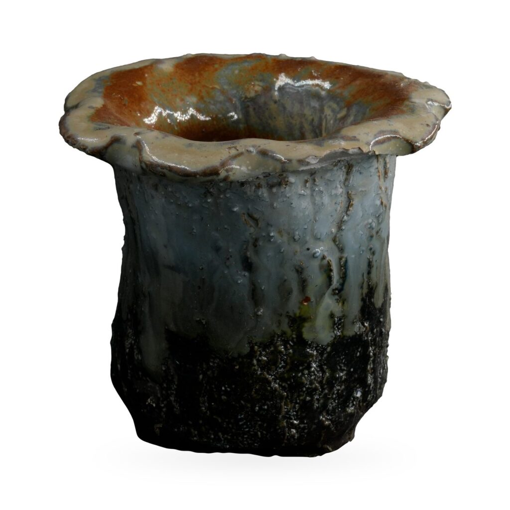 Ruffled-rim succulent pot with cream and blue-grey drip glaze over a textured near-black base
