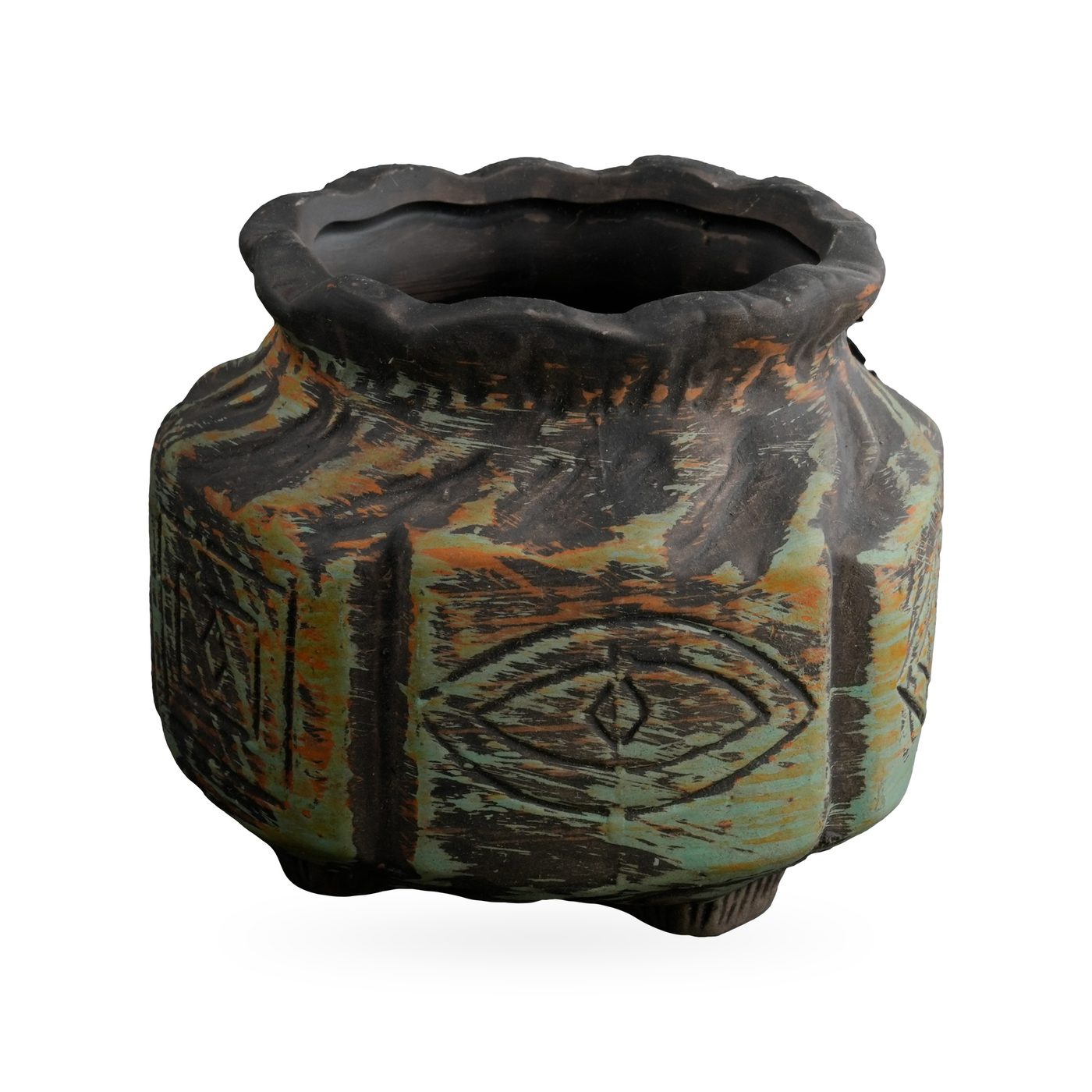 Rustic black and sage green pot with carved crescent moon, star and eye motifs and a wavy rim