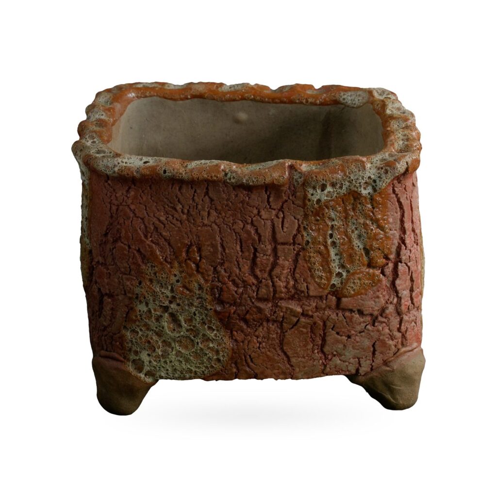 Square brick-red bark-texture footed pot with cream lava-style patches