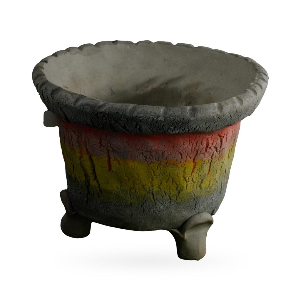 Rustic footed pot with charcoal crackle texture, red and yellow bands and scalloped rim