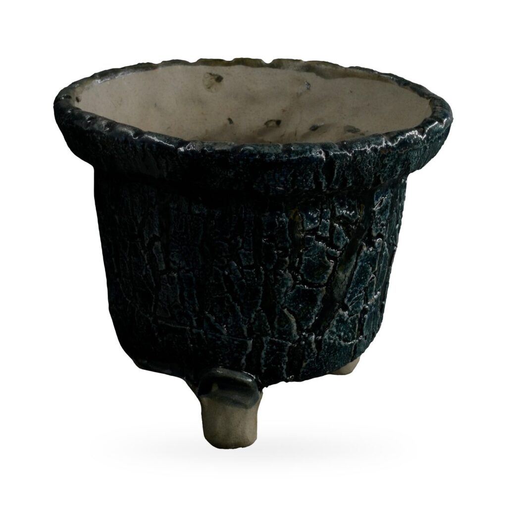 Tapered blue-black crackle glaze pot with scalloped rim on small stone-coloured feet