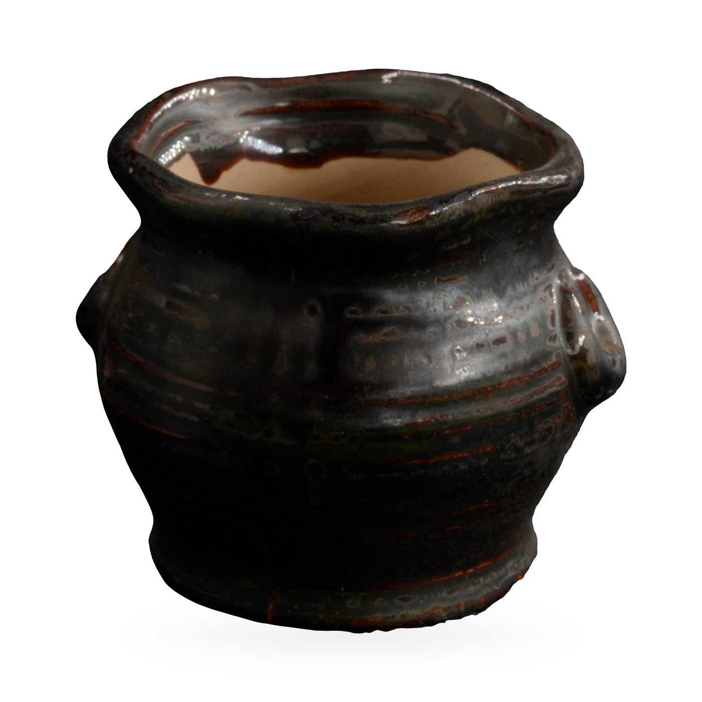Small black-brown glazed rustic pot with textured body, wavy rim and two small loop ears