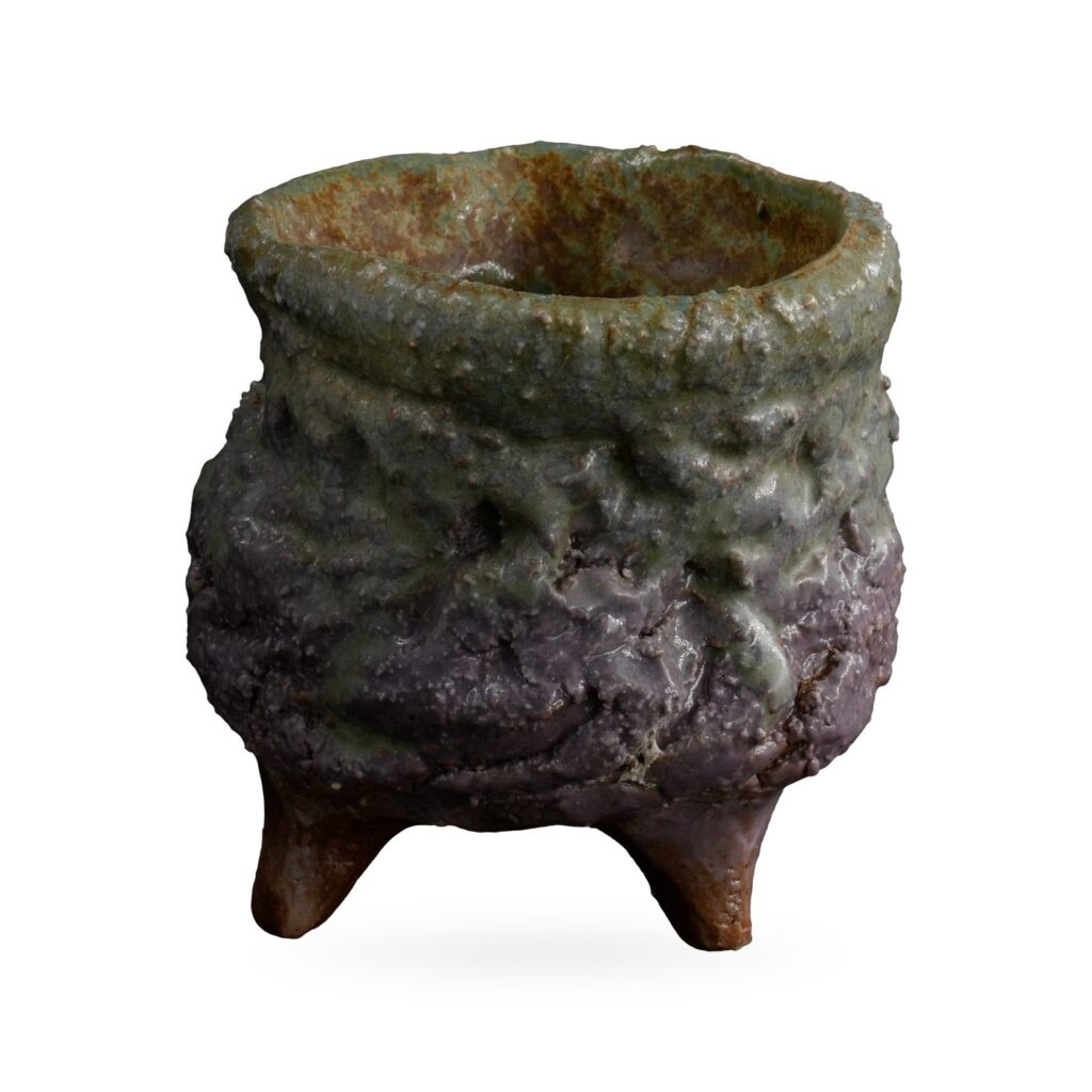 Rough-textured cauldron-style pot in sage green and dusky purple on small clay feet