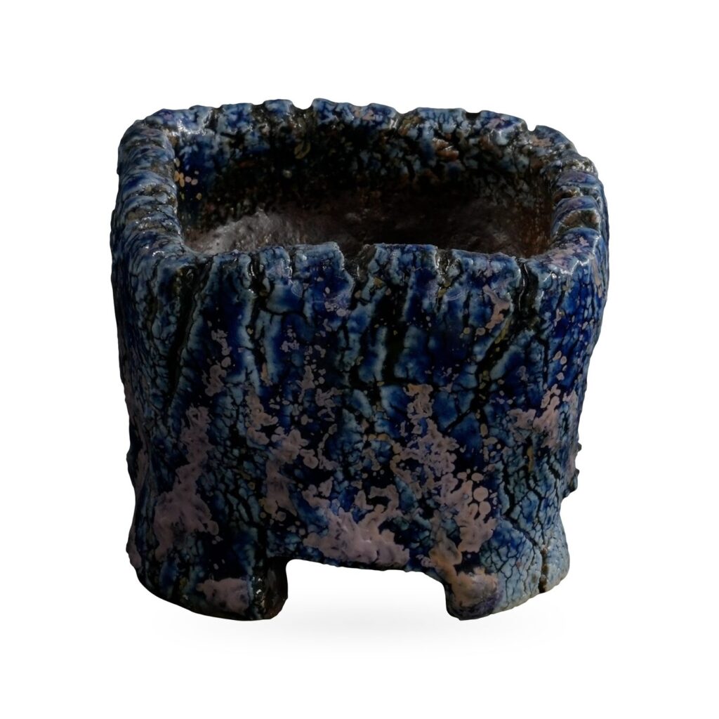 Mini square pot with bark-like texture in speckled cobalt blue and lilac glaze on low feet
