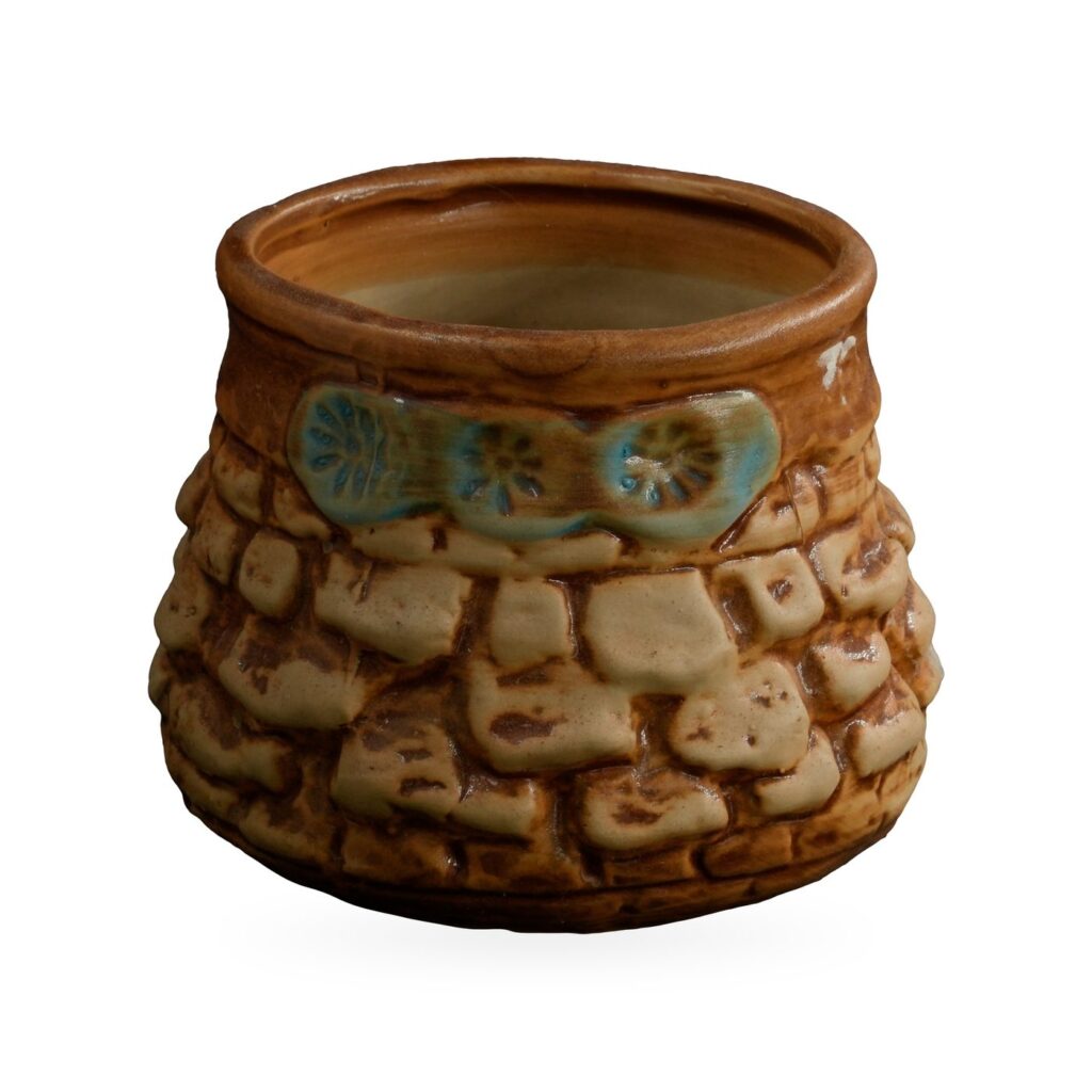 Rounded glazed pot with raised cream-and-brown cobblestone pattern and a blue-green flower band