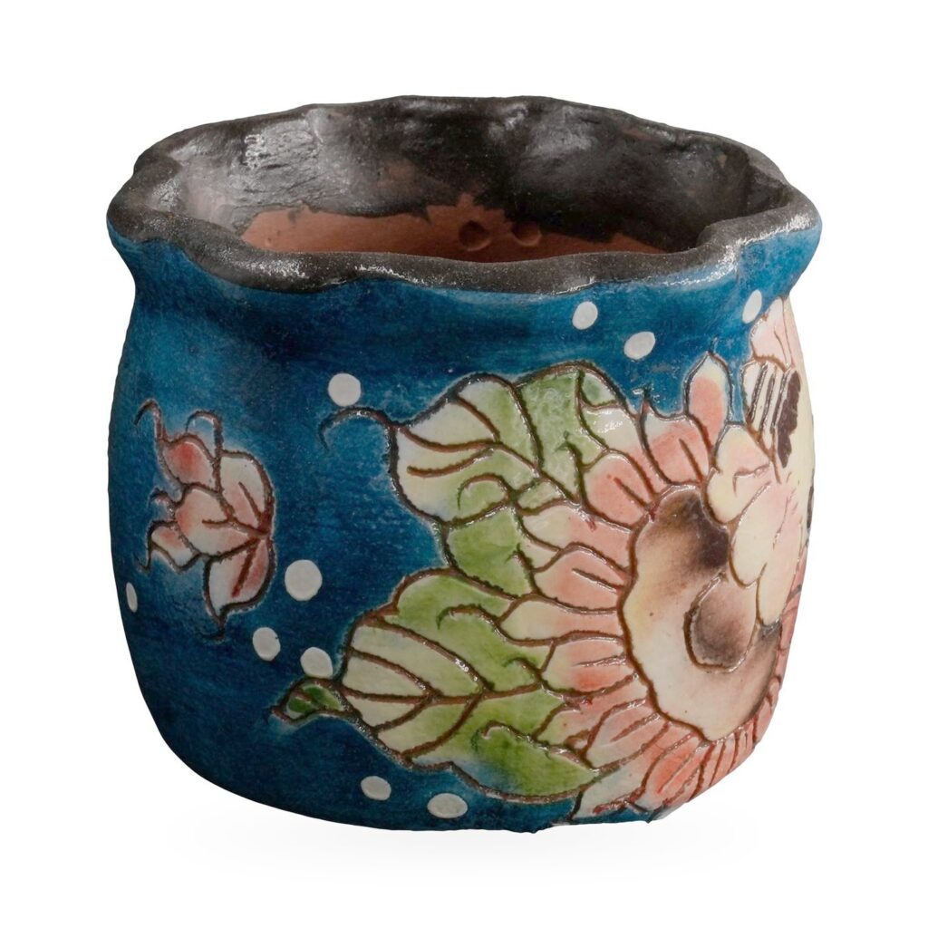 Cobalt blue painted succulent pot with peach sunflowers, a bee and a wavy dark rim