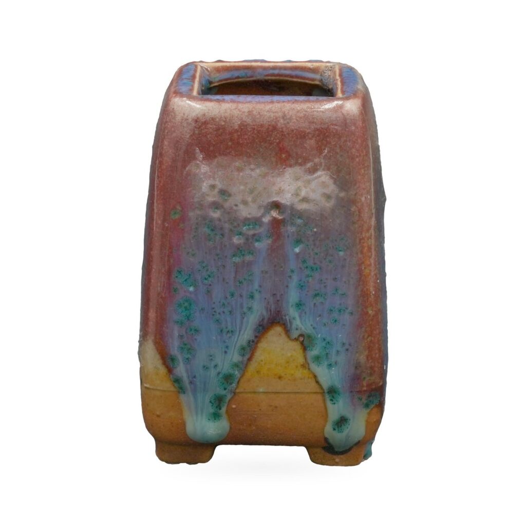 Tall square succulent pot in glossy oxblood-red glaze with blue and turquoise drips, on small feet